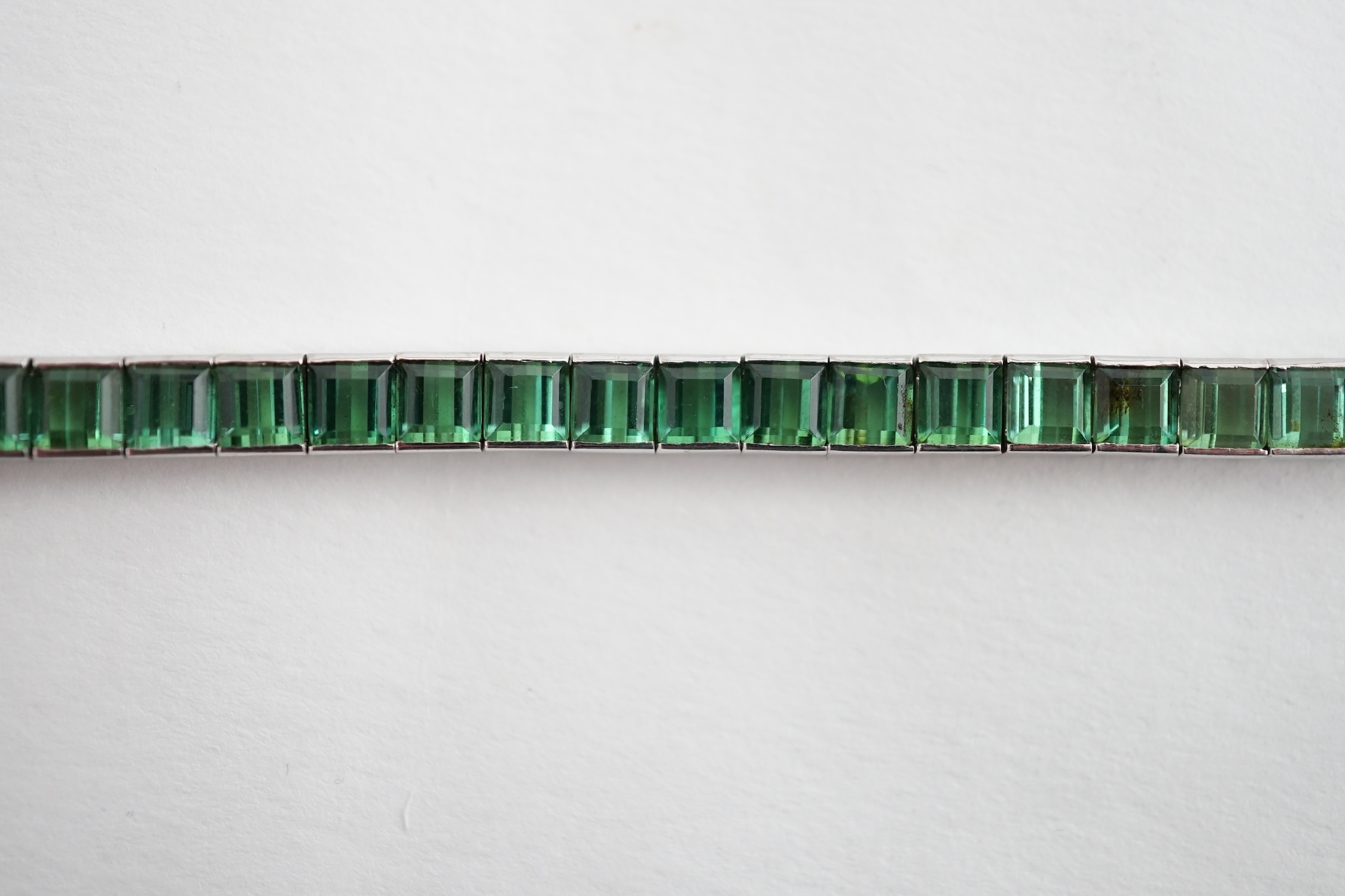 A white gold (tests as 18ct) and green tourmaline line bracelet